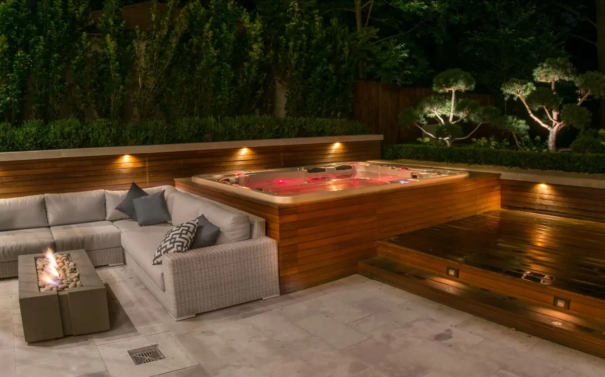 Jacuzzi Hydropool wbudowane w drewniany taras ze strefą wypoczynkową